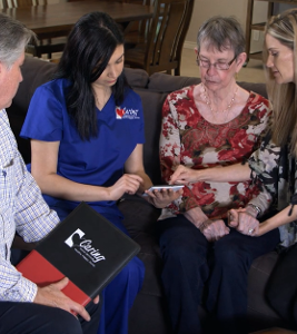 Caring Senior Service Care Manager and Caregiver showing a senior woman and her daughter a tablet-1-2