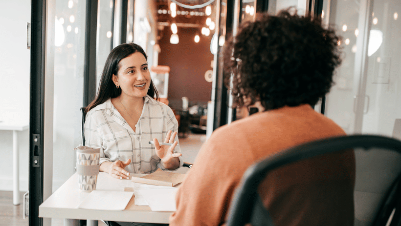 Female colleagues talking in a modern office space