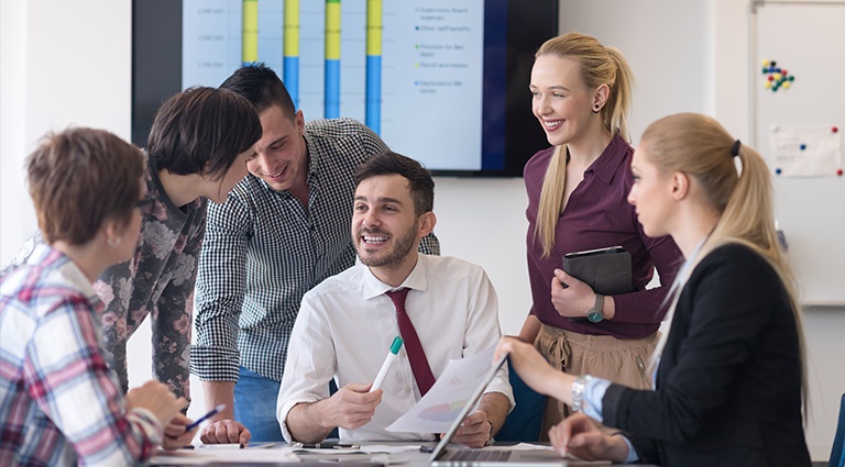 Group of young entrepreneurs reviewing business data