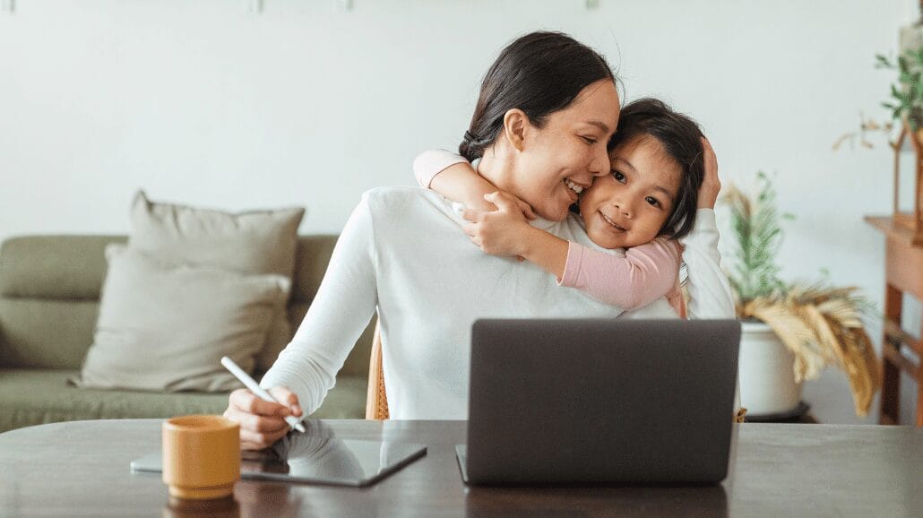 Working mother giving a hug to her daughter