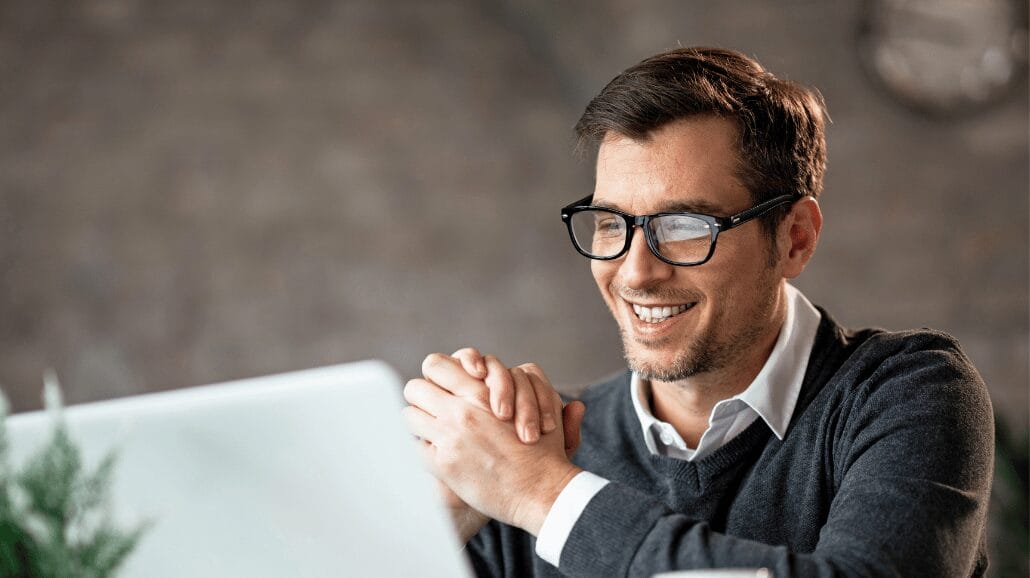 Young male entrepreneur looking at a computer screen