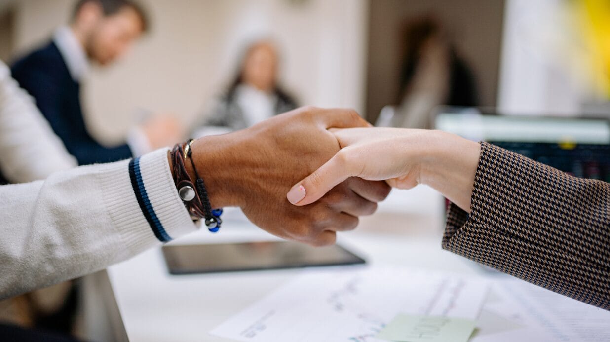 Business owners shaking hands at a team meeting